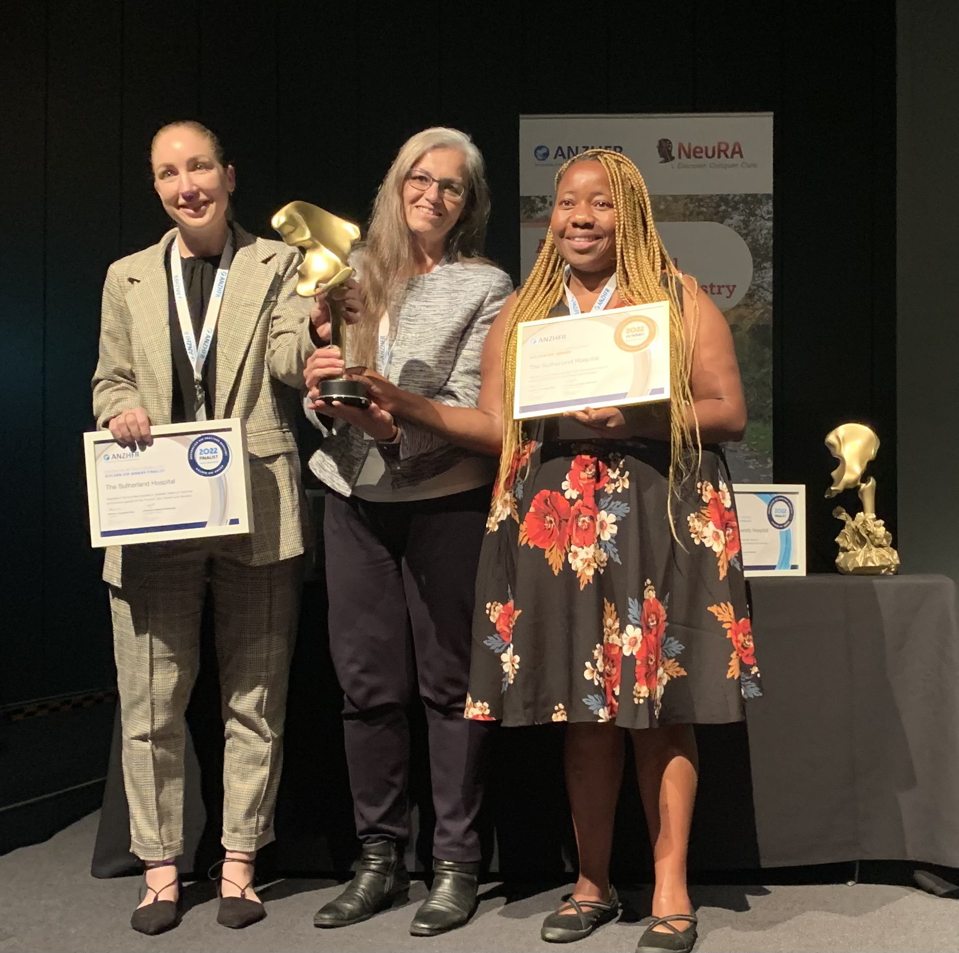 The Sutherland Hospital accepts the Golden Hip Award for Most Improved hospital, Australia,
Pictured: Ms Renee McLennan (Nursing Unit Manager, Orthopaedics, TSH), Dr Alice Bhasale (Director, Clinical Care Standards, ACSQHC) &amp; Ms Juliana Zvavanjanja, CNC Orthopaedics, TSH 